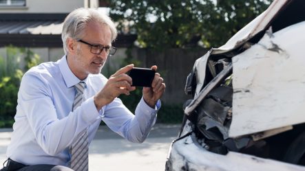 Man taking photos of a hit car