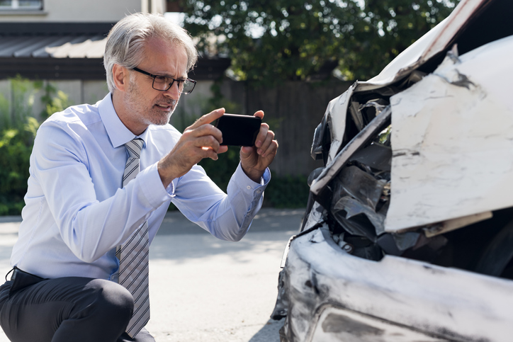 Man taking photos of a hit car