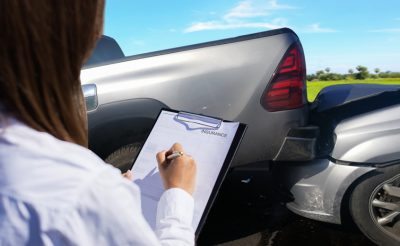 adjuster filling out form after a car accident