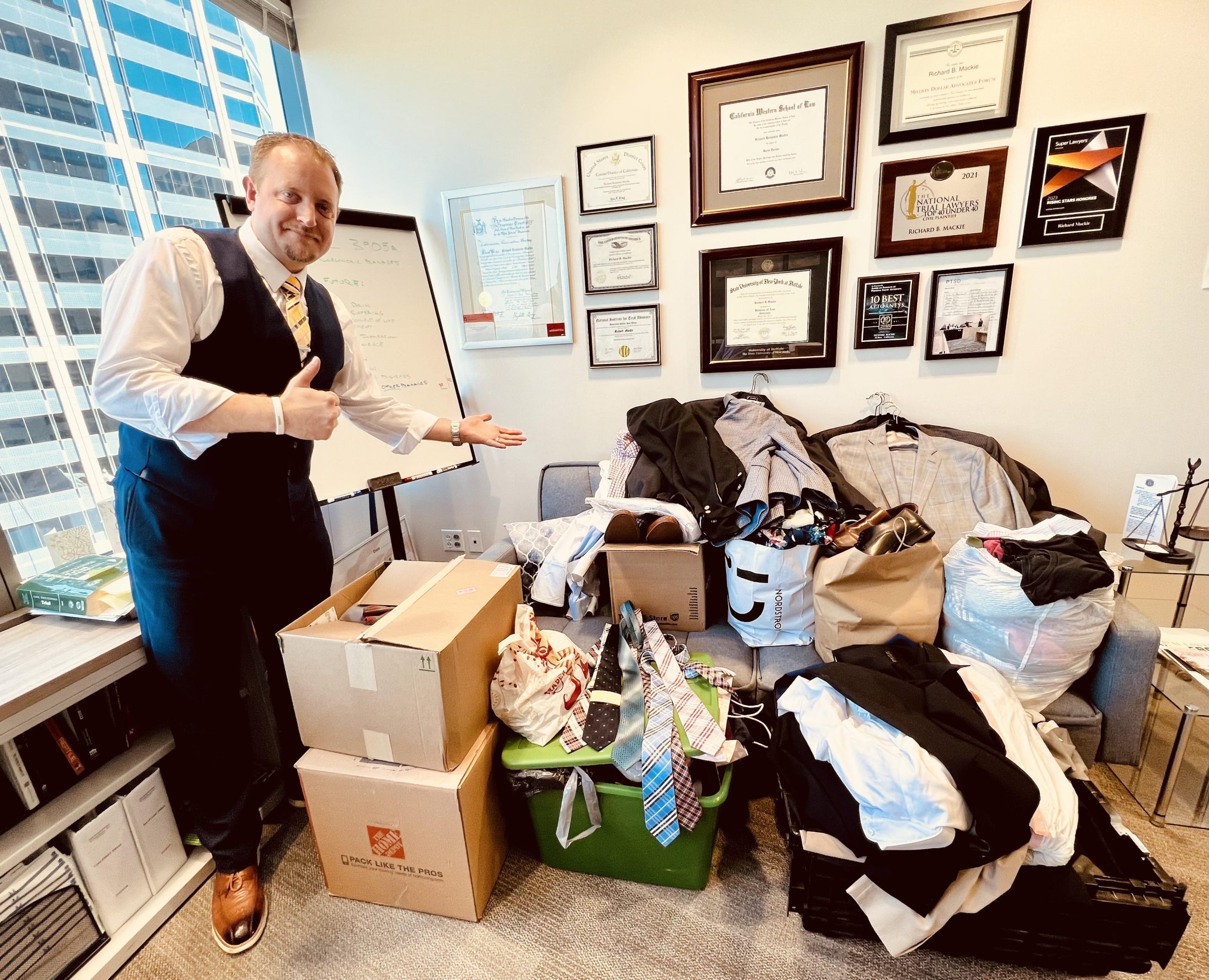 Richard Mackie standing with donated clothing for veterans